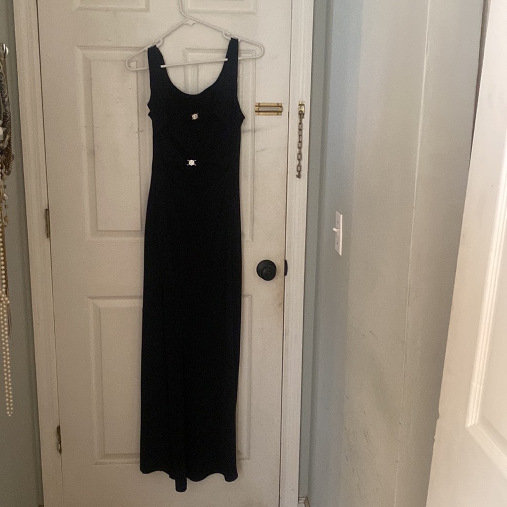 Black backless long straight dress.  2 small rhinestones in the back of dress.